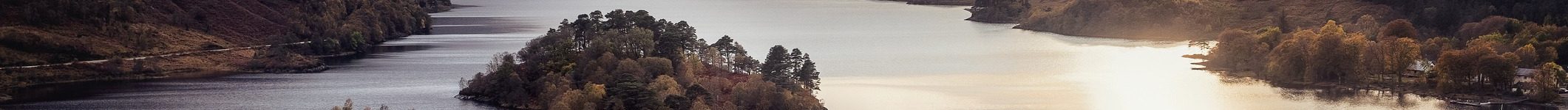 View with famous Scottish lake Loch Shiel with Glenfinnan monument on sunset View with famous Scottish lake Loch Shiel with Glenfinnan monument on sunset